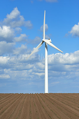 Buy stock photo Wind turbine and environmental infrastructure isolated against blue sky with copyspace on empty windmill energy farm. Propellers converting sustainable energy into electric power in remote rural area