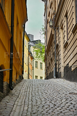 Buy stock photo Travel, stone and alley in vintage town with history, culture or holiday destination in Sweden. Vacation, old buildings and antique street in Stockholm with cobble road architecture in ancient city.