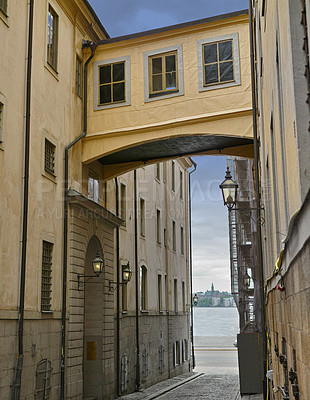 Buy stock photo Skybridge, architecture and city with vintage building in old town with history, culture and calm holiday destination. Vacation, travel or quiet alley in Sweden with retro aesthetic in ancient street