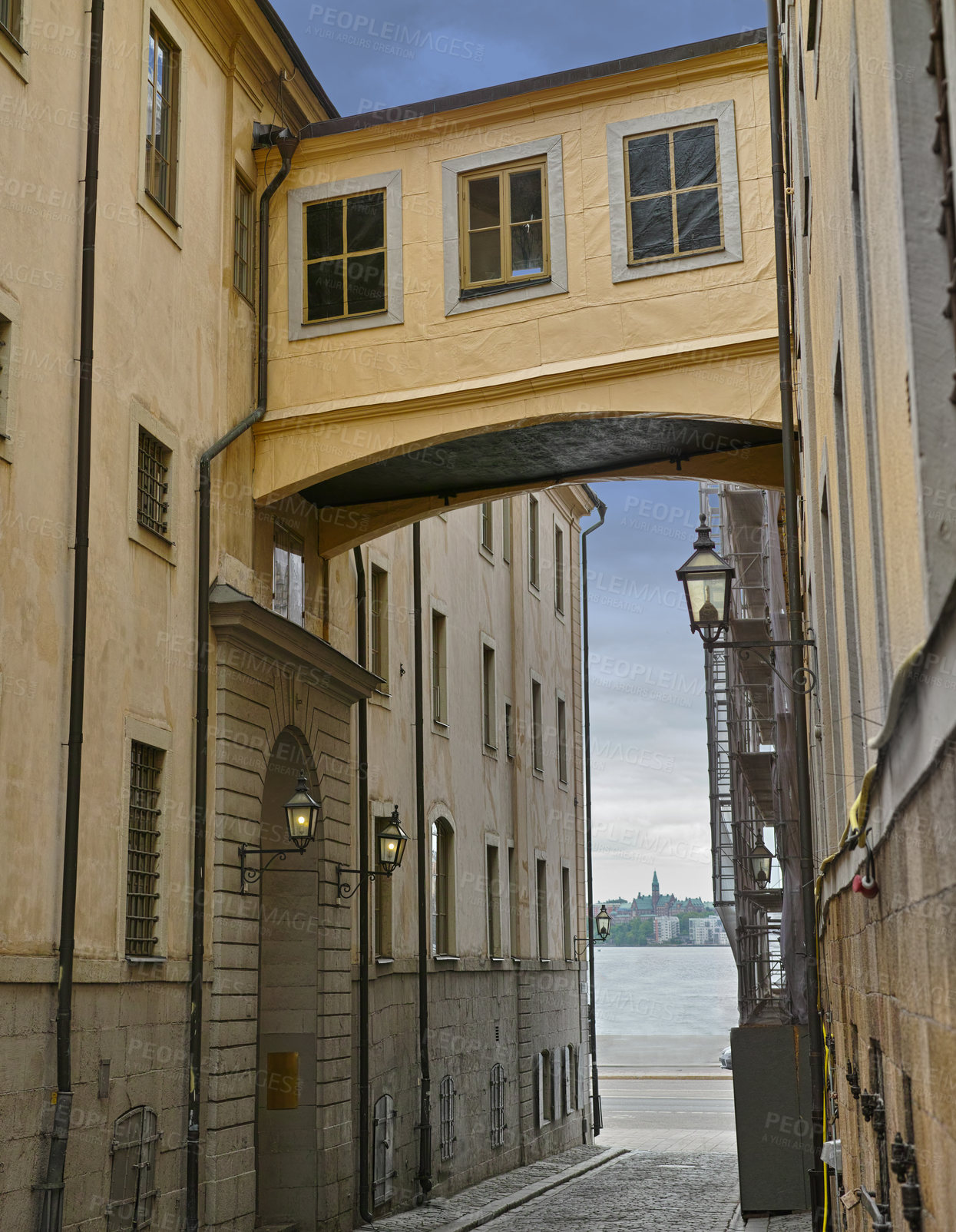 Buy stock photo Skybridge, architecture and city with vintage building in old town with history, culture and calm holiday destination. Vacation, travel or quiet alley in Sweden with retro aesthetic in ancient street
