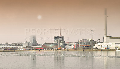 Buy stock photo Harbor, industrial buildings and town in outdoors, treatment plant and development by factory. Production, warehouse and power station or refinery in Aarhaus, Denmark and river or lake outside