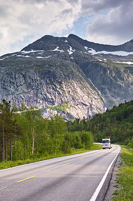 Buy stock photo Mountain, road trip and truck in forest with travel, holiday and countryside scenery in Norway. Nature, clouds in sky and asphalt for journey, vacation or outdoor adventure with snow, trees and woods