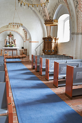 Buy stock photo Christian, shrine or altar in church for religion, worship and spiritual space for ceremony in Danish culture. Praise, god and sculpture of Jesus in chapel with furniture, seat on aisle and hallway