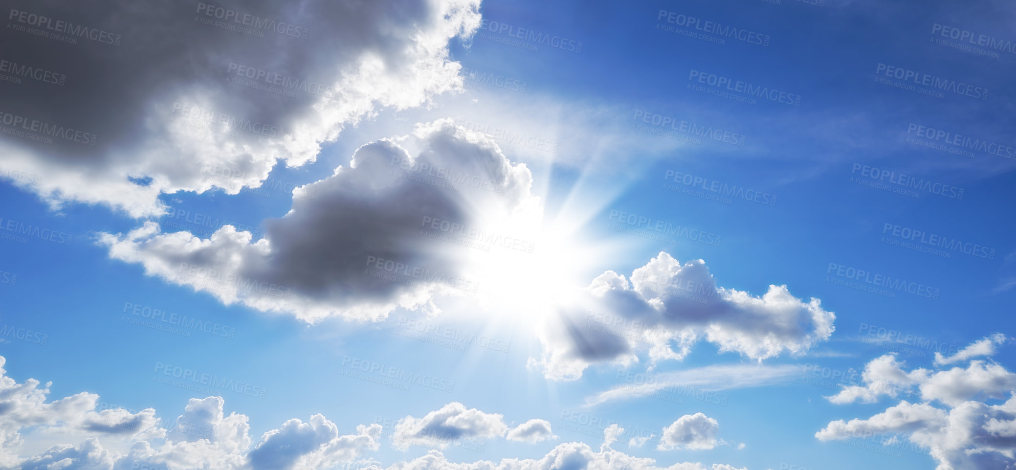 Buy stock photo Sunbeams shining through dark clouds in the sky