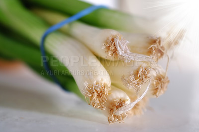 Buy stock photo Vegetable, closeup and spring onions for cooking, food and nutrition at home, house and kitchen with macro on table. Leeks, edible plants and fresh produce for vegan dish, clean eating and diet
