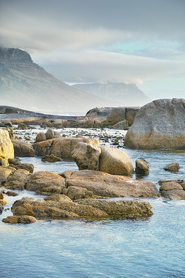 Buy stock photo Ocean, rocks and landscape with beach and outdoor, travel with summer vacation in South Africa. Environment, seaside location and tropical destination with journey to sea and nature with adventure