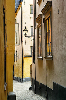 Buy stock photo Travel, buildings and alley in ancient town with history, culture or holiday destination in Sweden. Vacation, old architecture and antique stone street in Stockholm with cobble path in vintage city