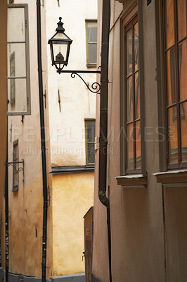 Buy stock photo Travel, alley and lamp on vintage building in old town with history, culture or holiday destination in Sweden. Vacation, architecture and antique lantern in Stockholm with retro light in ancient city