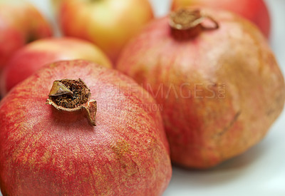 Buy stock photo Closeup of pomegranates lying on a plate