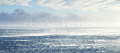 Buy stock photo Clouds, sky and sea with rocks in nature for vacation, holiday or weekend trip in summer. Stones, banner and ocean waves by tropical island for travel in Cape town for outdoor paradise scenery.