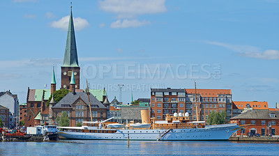 Buy stock photo Harbor, ship and city in nature outdoors, travel and yacht on holiday or vacation or location. Urban, historic building and boat on water for peace or calm in Aarhaus, Denmark and river on getaway
