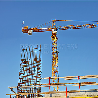 Buy stock photo Low angle view of a crane on a construction site