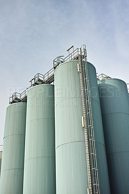 Buy stock photo Silo storage tankers against a gray sky in Danish oil industry. large oil plant storage tanks for export in industrial area. Silo tankers for keeping bulk food products, substances and materials safe