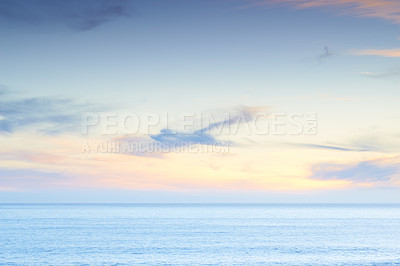 Buy stock photo A calm ocean underneath a sky with wispy clouds