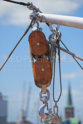 Buy stock photo Closeup, pulley and hook with rope on ship, dock or harbor with transport and navigation for sailing. Yacht, cruise with journey or travel, cable and chain for nautical vessel, equipment and rigging