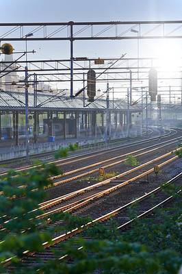 Buy stock photo Railway, station and platform building for travel with tracks, steel infrastructure and cables with sunrise in nature. Railroad, transport industry and terminal structure for commute, transit or trip