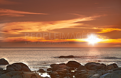 Buy stock photo Ocean, sunset and clouds on horizon or seascape and outdoor travel for vacation in nature. Landscape, beach and sunlight on water in environment, waves and rocks in cape town for tourist destination