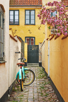 Buy stock photo A bicycle parked in a small alley next to a house in Dragoer, Denmark