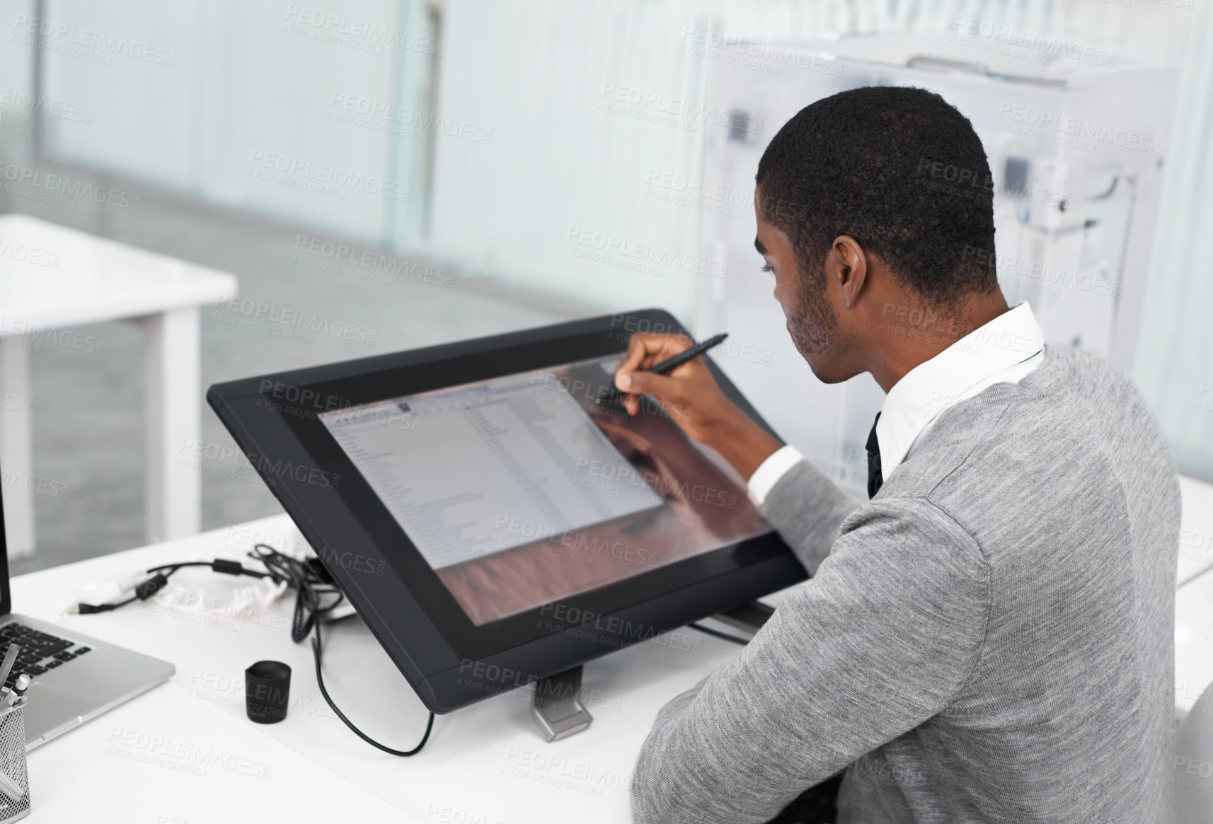 Buy stock photo A young man working on a large touchscreen