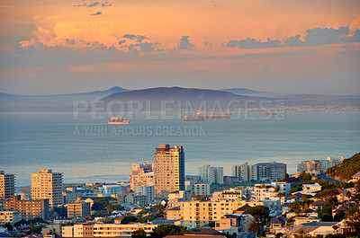 Buy stock photo City, building and ocean sunset with development infrastructure for summer holiday, explore or downtown. Water, urban and sea or mountain in South Africa or calm nature or evening, vacation or trip