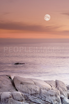 Buy stock photo Sunset, ocean and rock in seaside with water, waves and clouds in golden sky. Tropical island, stone and seashore or sand in beach landscape, summer or evening and scenic view with moon for peace