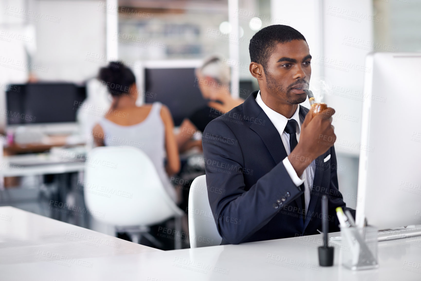 Buy stock photo A young businessman smoking an electronic pipe indoors