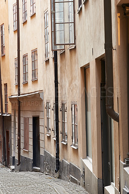 Buy stock photo Travel, architecture and alley in vintage town with history, culture or holiday destination in Sweden. Vacation, old buildings and antique street in Stockholm with retro cobble road in ancient city