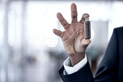 Buy stock photo Cropped shot of an african businessman holding up a usb