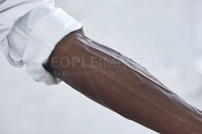Buy stock photo Strong, person and vein from muscle in arm with shirt, fashion and closeup in white background. African, skincare and forearm of model with healthy fitness, wellness or muscular bodybuilder in office