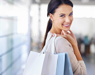 Buy stock photo A beautiful brunette carrying shopping bags