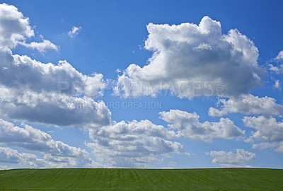 Buy stock photo Beautiful cumulonimbus clouds over a green meadow