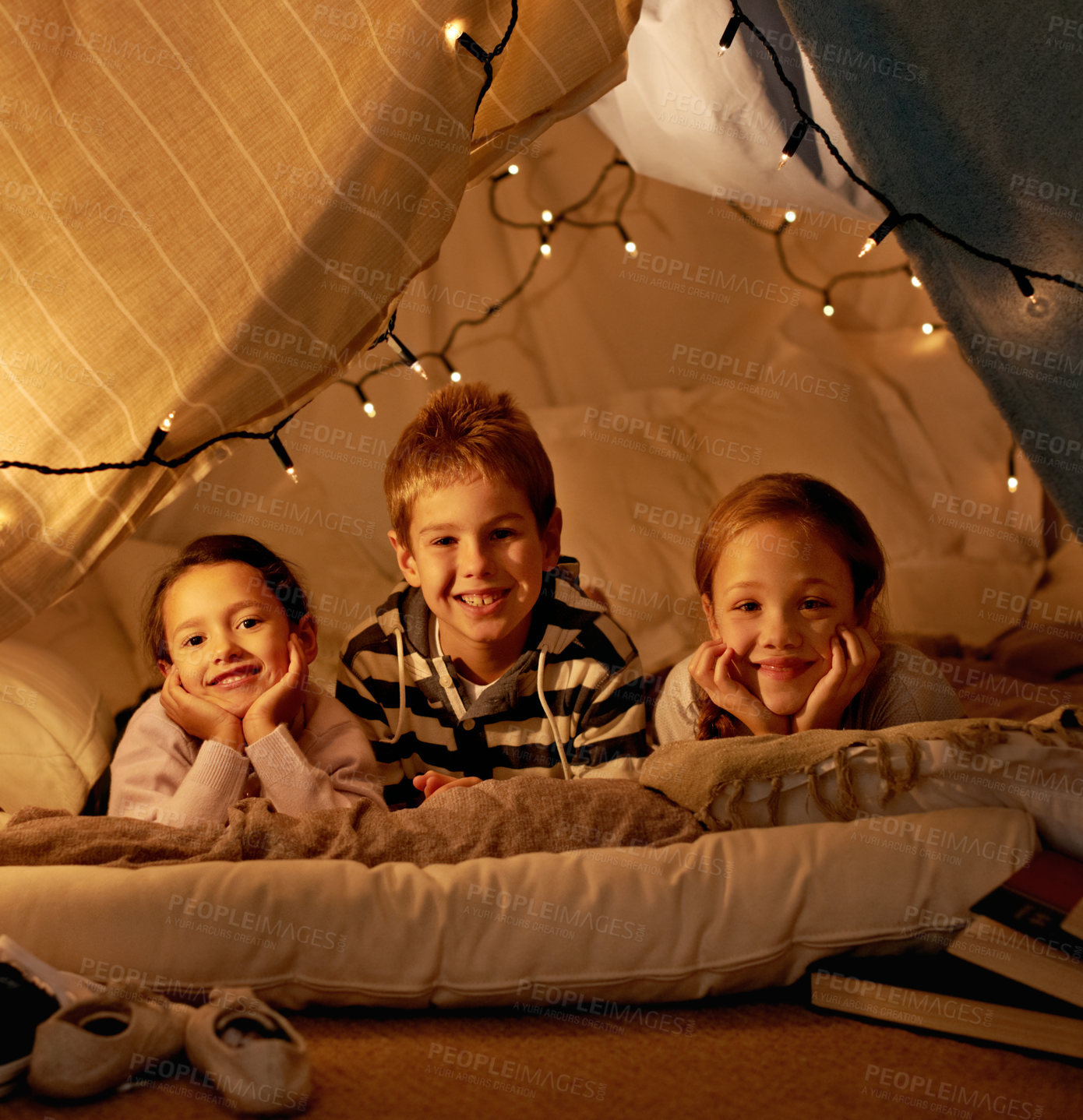 Buy stock photo Kids, happy and playing in blanket fort with portrait for fantasy, bonding and fairy lights at night. Friends, children and face with smile for pajama party, sleepover and pillow tent with lighting 