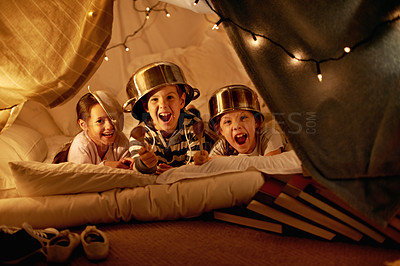 Buy stock photo Tent, lights and portrait of children at night in bedroom for playing, fun and bonding at home. Friends, youth and happy kids with spoon, helmet pots and blanket fort for games, relax and childhood