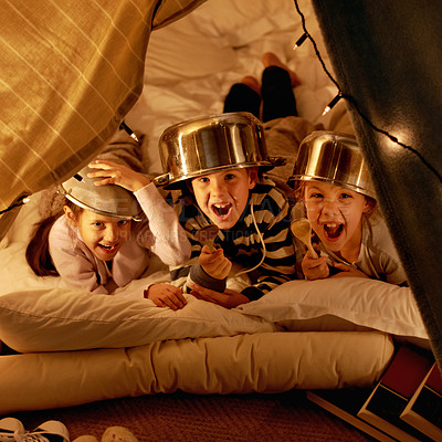 Buy stock photo Children, portrait and siblings with pot helmet in a fort for fantasy, learning or playing in their home. Happy family, face and kids on a floor with tent games, development or fun bonding in a house