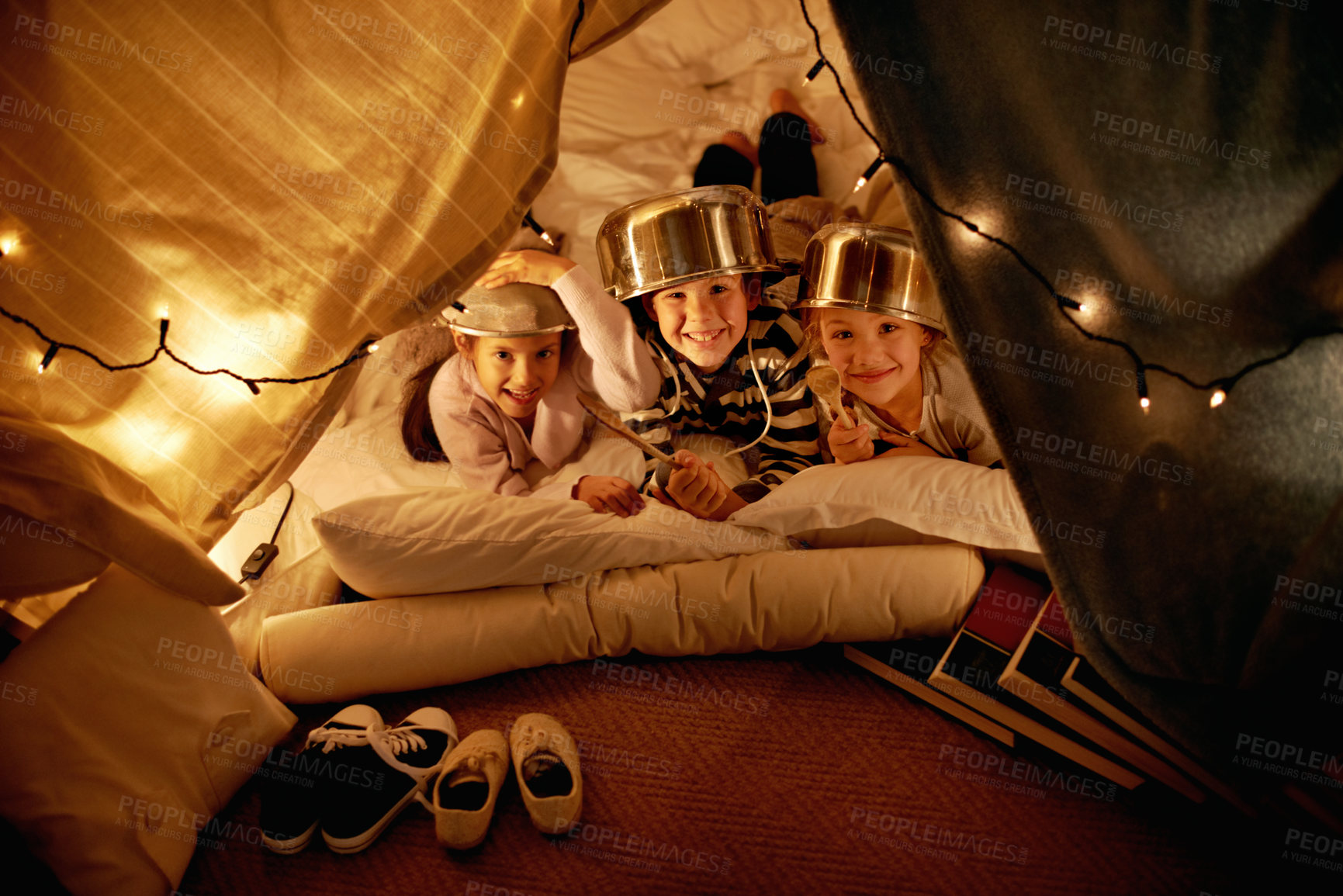 Buy stock photo Portrait, children and siblings with pot helmet in a fort for fantasy, learning or playing in their home. Happy family, face and kids on a floor with tent games, development or learning in a house
