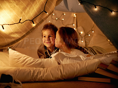 Buy stock photo Children, happy and playing in tent at night with love, kiss and bonding for holiday adventure or vacation. Young boy, girl or kids by fairy lights, pillows and blanket at home with thinking or ideas
