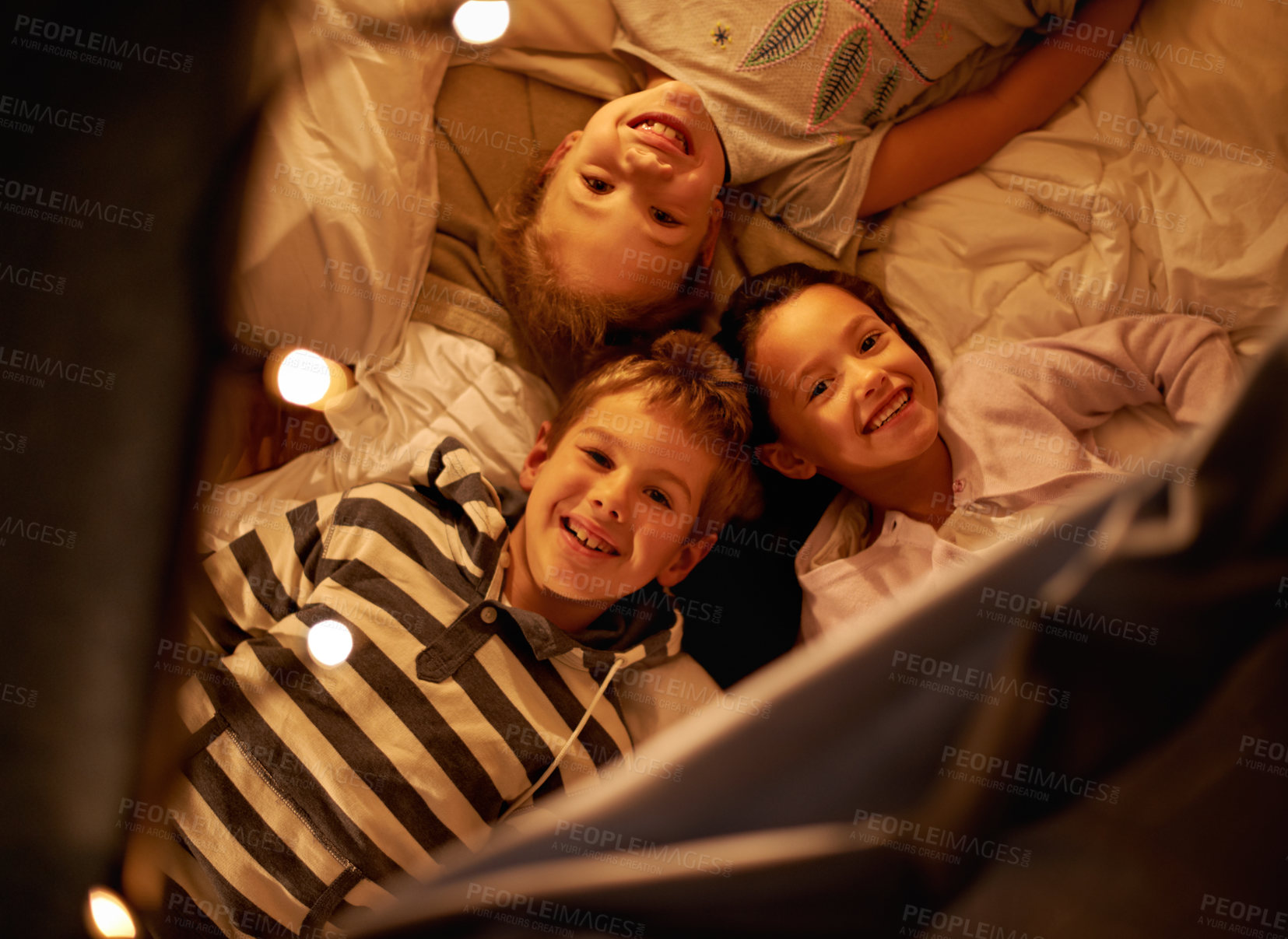Buy stock photo Children, portrait and above siblings in a bed with love, support and trust while bonding at home together. Family, night and face of kids in a bedroom for evening games, playing or indoor camping