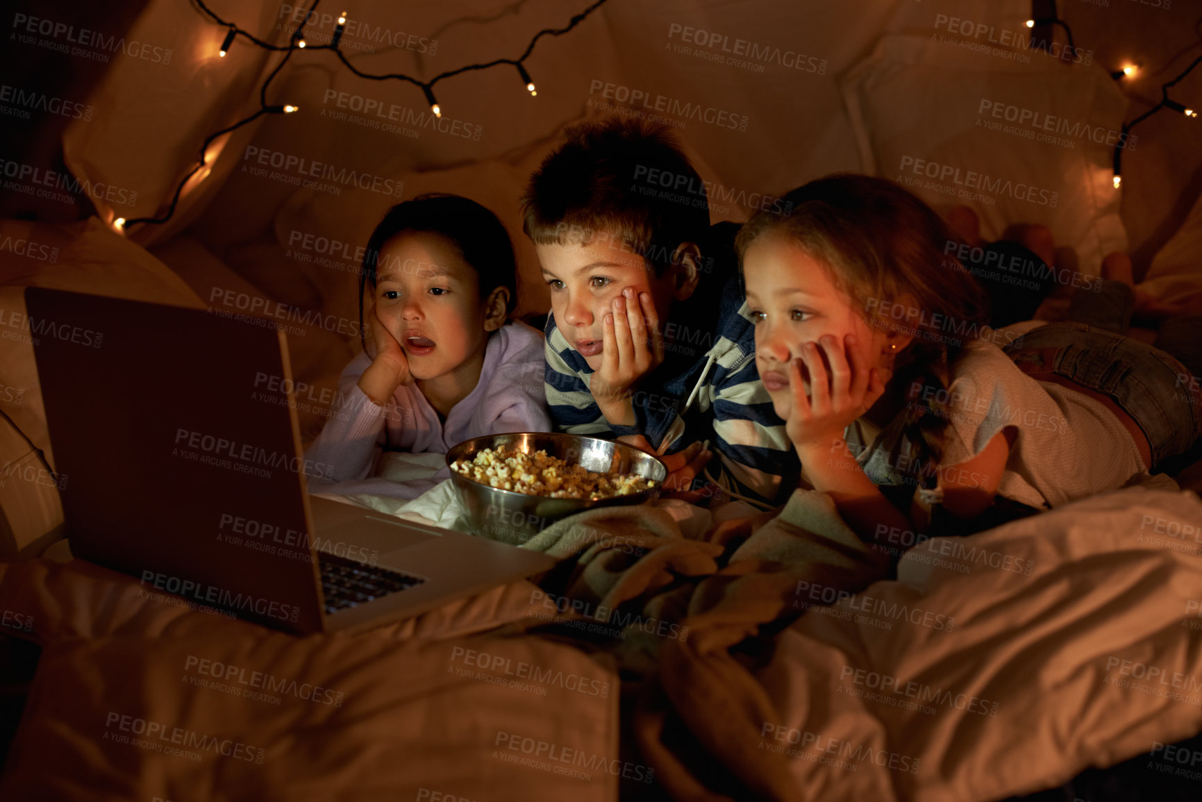 Buy stock photo Children, laptop and watch in tent at night with movies, film or cartoons for holiday adventure or vacation. Young boy, girl or kids with lights, pillows and blanket at home on computer for Netflix