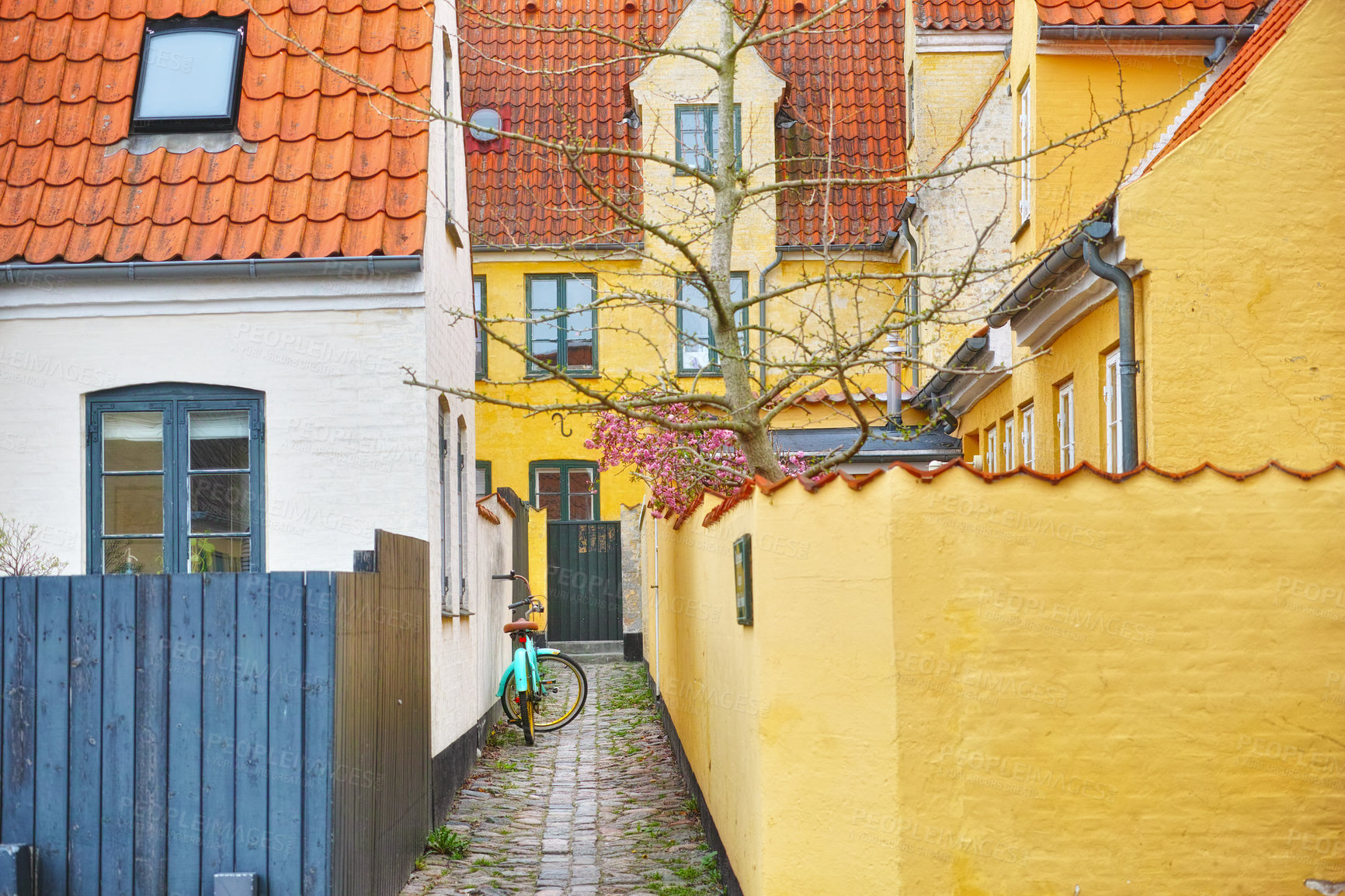 Buy stock photo Town, house and bicycle in alley with architecture for heritage or traditional community with colorful buildings. Village, street and cultural in small neighborhoods with rich history in Germany