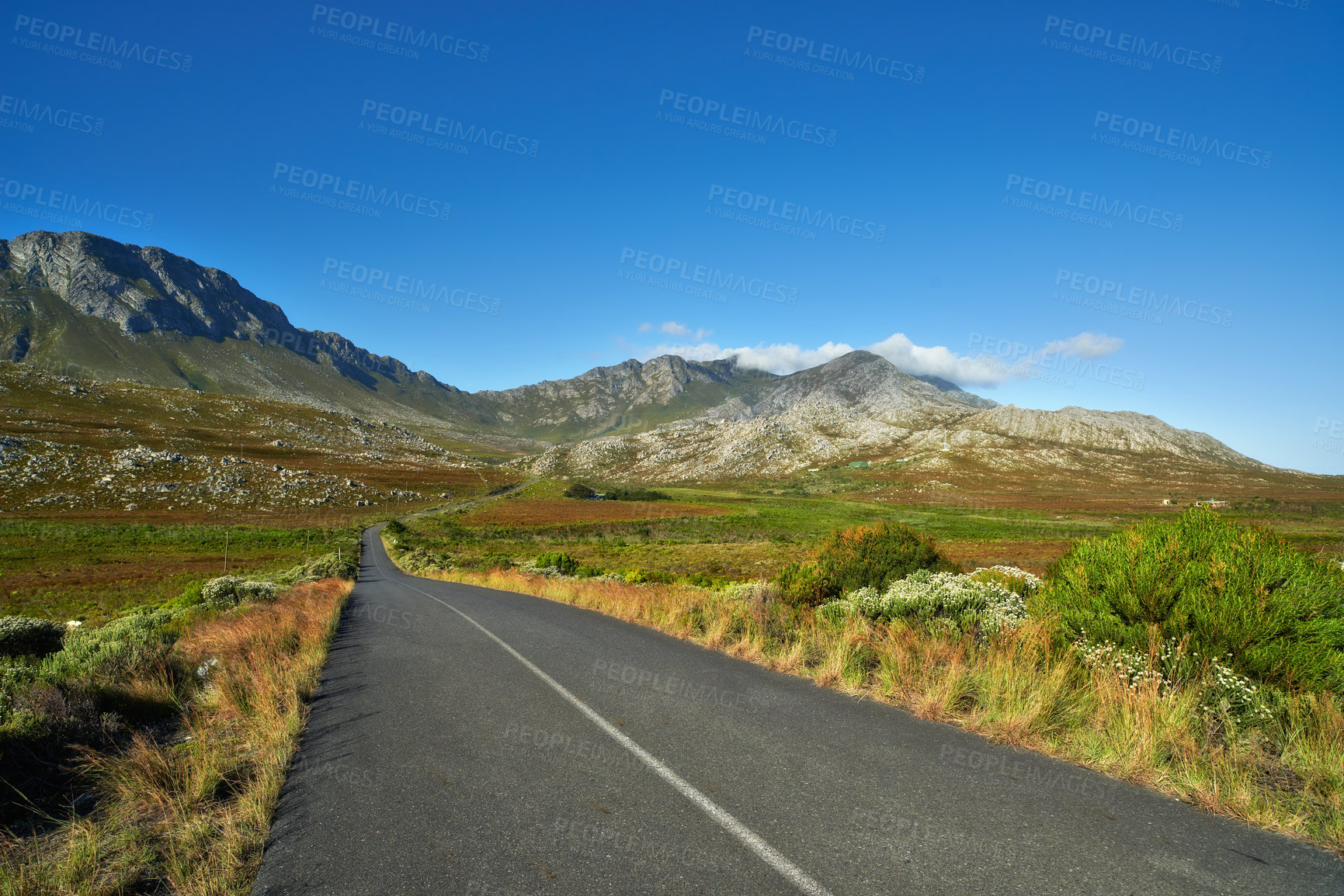 Buy stock photo Mountain, road trip and natural landscape with grass, holiday or green scenery in countryside. Nature, grass and highway for journey, vacation or outdoor adventure with blue sky, relax and tranquil