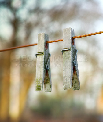 Buy stock photo Two wooden washing pegs on a line.Two old wooden clothespins hanging on a washing line in a sunny garden. Old fashioned tools used for hanging freshly cleaned laundry
