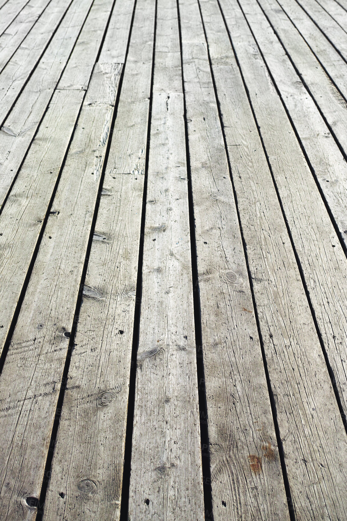Buy stock photo Closeup of a wooden plank surface. Light grey vintage flooring with slats forming an outdoor terrace. Old textures of hard wood floor used as a walkway or deck. Long vertical outdoor floorboards