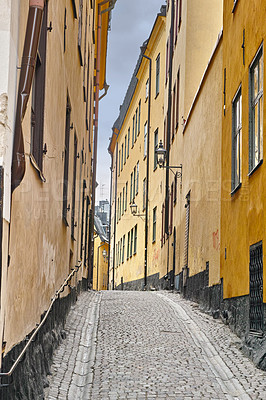 Buy stock photo Travel, architecture and street in vintage alley with history, culture or holiday destination in Sweden. Vacation, old buildings and antique stone road in Stockholm with cobble path in ancient city