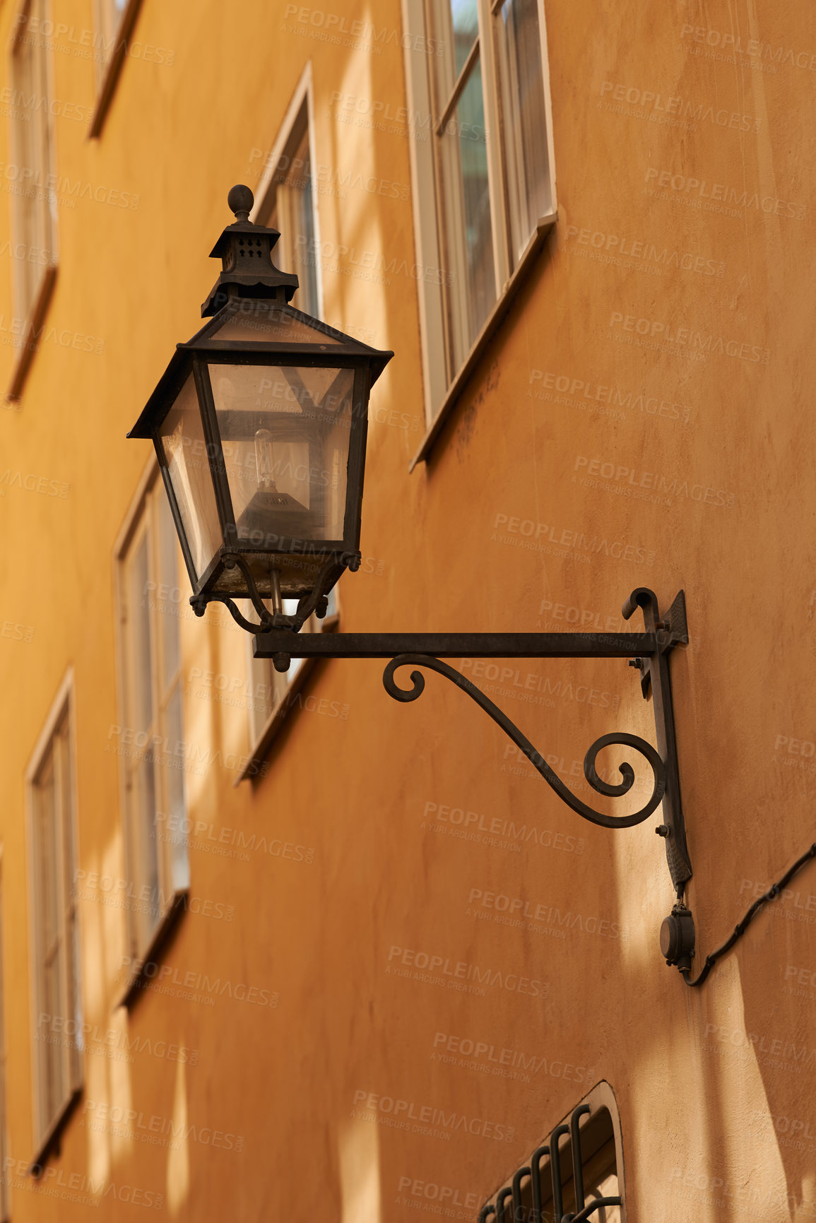 Buy stock photo Travel, wall and lantern on vintage building in old town with history, culture or holiday destination in Denmark. Vacation, architecture and antique lamp in Europe with retro light in ancient city