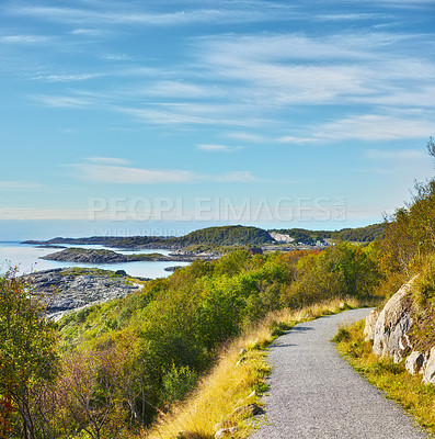 Buy stock photo Road, landscape and sky with ocean in nature for travel, adventure and trees with mountain view in Norway. Path, coastline and location with hill, roadway and environment for holiday and direction