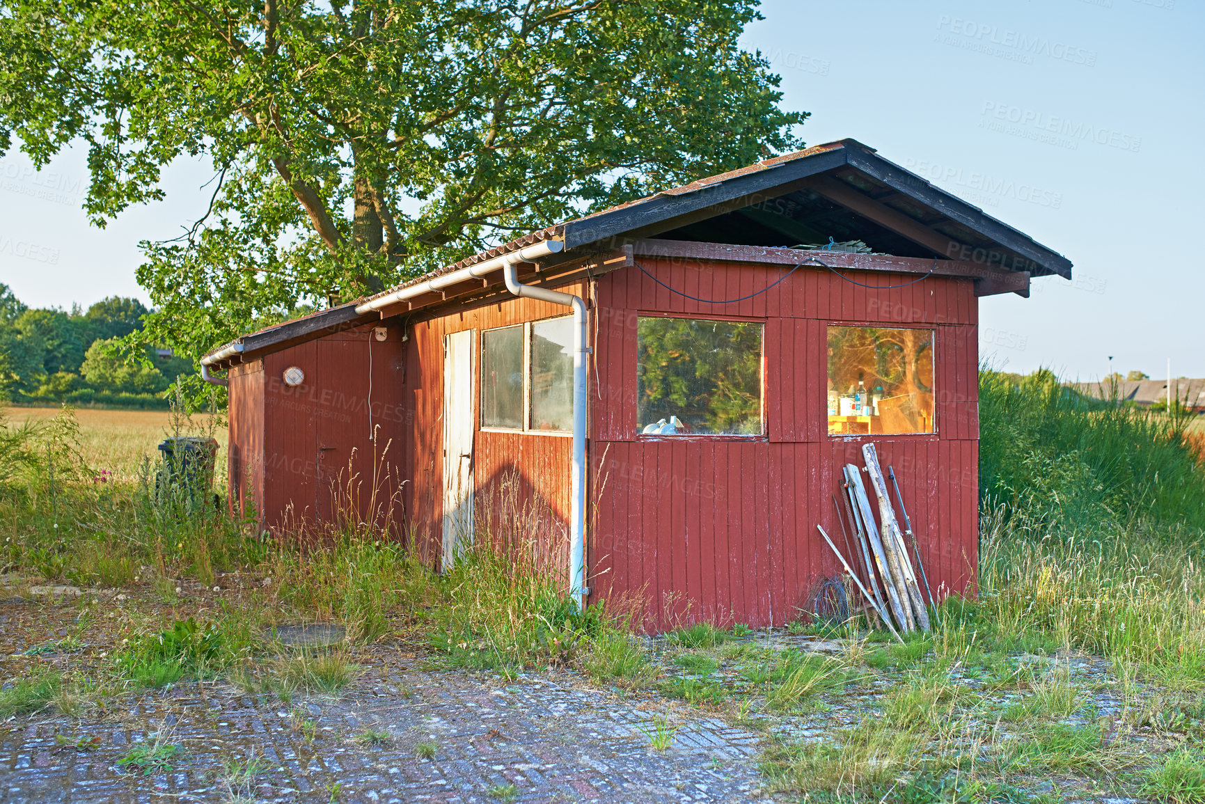 Buy stock photo Countryside, grass and field with broken cabin with vintage architecture on neighborhood in Texas. Ghost town,  countryside and house with rust in quiet community with nature and woods in village 