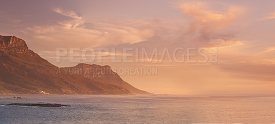 Buy stock photo Landscape, ocean and sunset background by mountains for environment, travel or adventure. Banner of the sea in nature with clouds, golden light and paradise and island for holiday, art and vacation