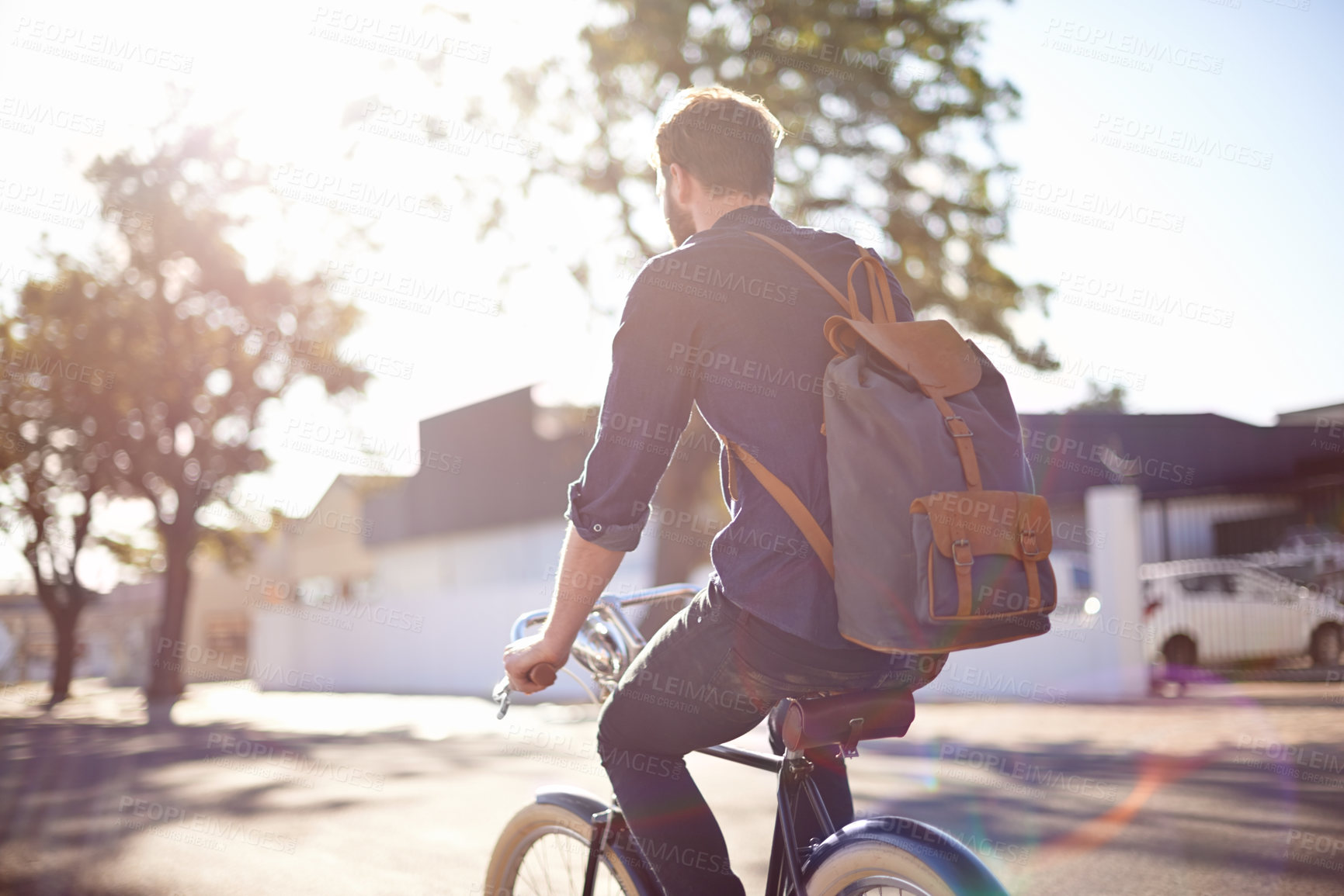 Buy stock photo Bicycle, transport and man cycling in road with lens flare for exercise, commute and riding in morning. Travel, city and male cyclist on bike for eco friendly traveling, carbon neutral and journey