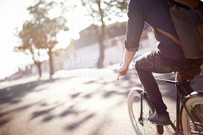 Buy stock photo A young man riding a bicycle outdoors