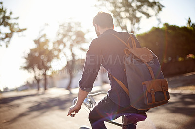 Buy stock photo Bicycle, travel and back of man in street with lens flare for exercise, commute and cycling in morning. Transport, city and male cyclist on bike for eco friendly traveling, carbon neutral and journey